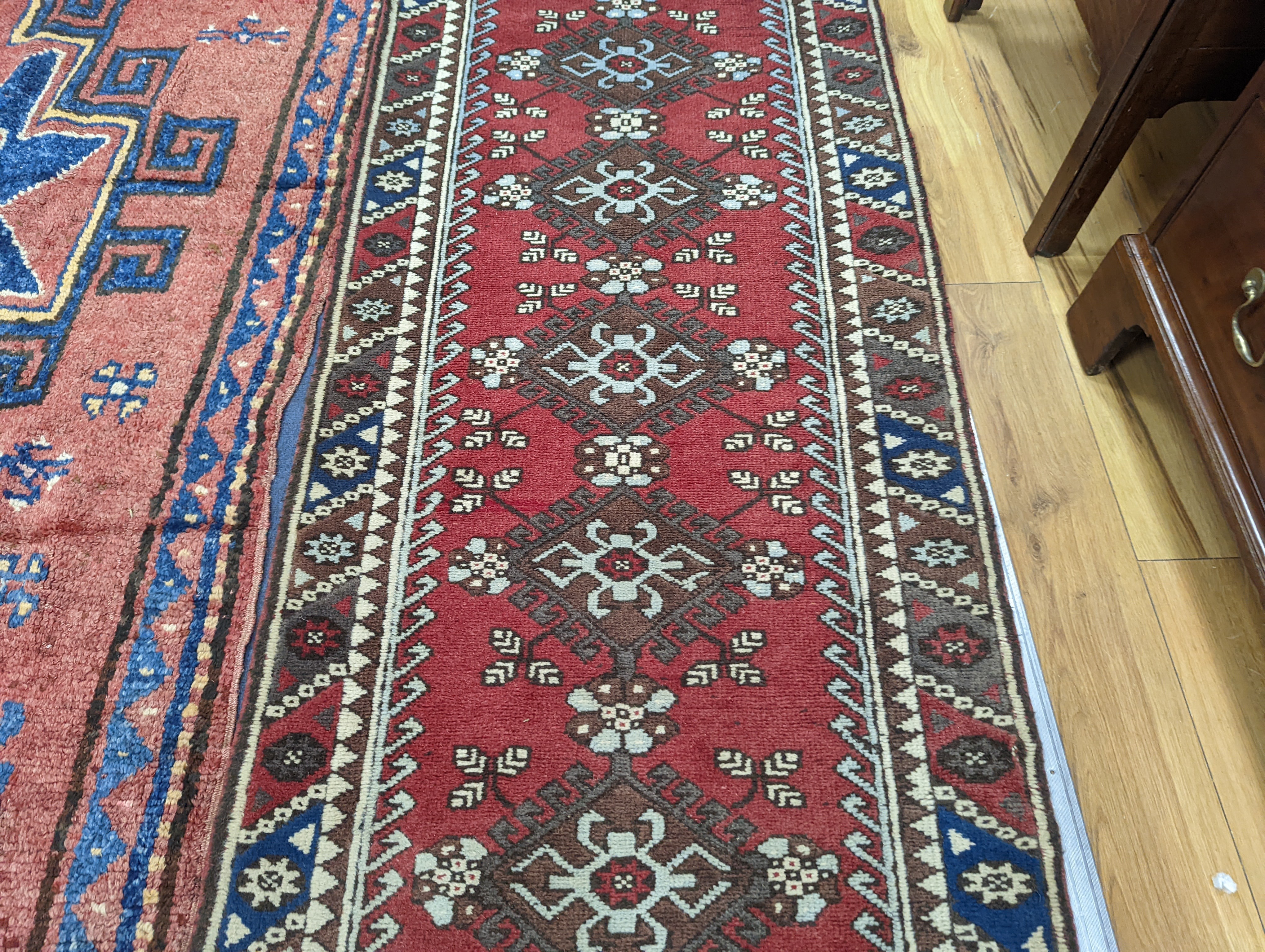 A Caucasian design red ground runner, 300 x 78cm